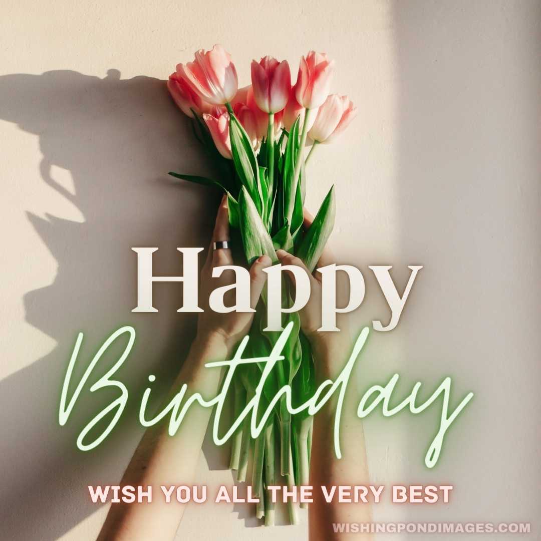 Hands holding pink tulips in morning soft light on white rustic wall near window - Happy Birthday Fl